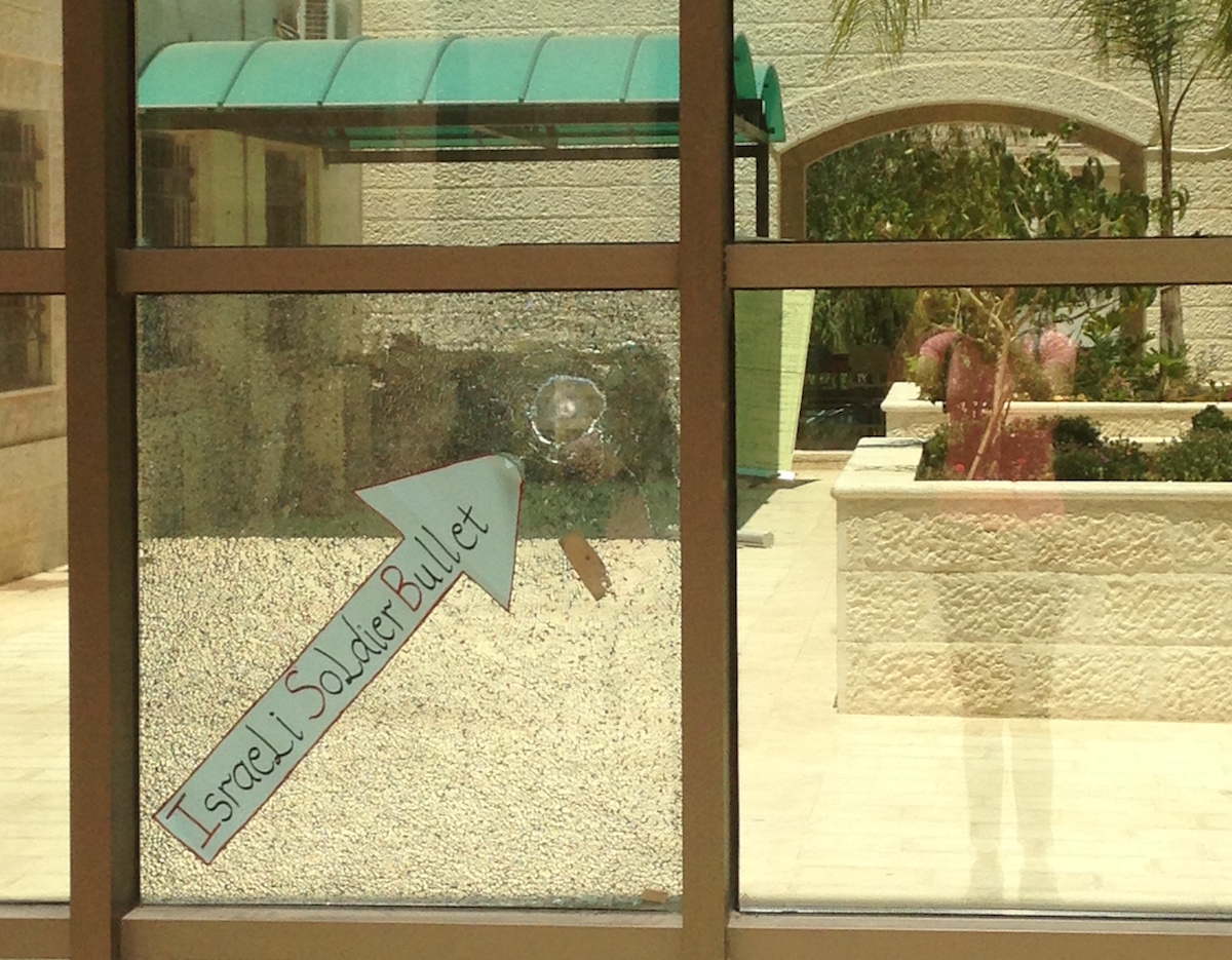 A bullet hole in the window of the library at the Palestine Technical University-Kedoorie, in Tulkarem, resulting from an IDF incursion in which numerous students and staff were injured, December 2015. (Photo: Lenora Hanson)